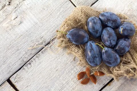 Fresh blue plums on white rustic table, top view Stock Photos