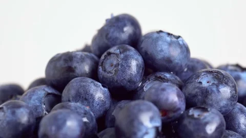 Fresh blueberries on white background, macro, slow motion, rotation. Group .. Video stock 231110512