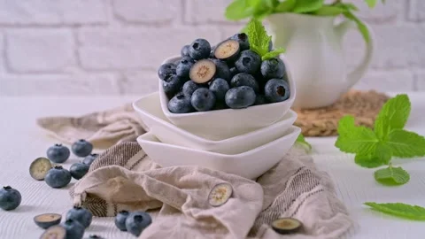Fresh blueberries in a white square bowl with mint Stock Footage 337205997