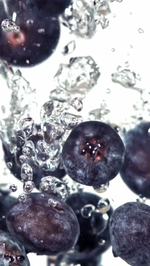 Fresh blueberry fall underwater with bubbles. Filmed is slow motion 1000 fps Stock Footage 335292024