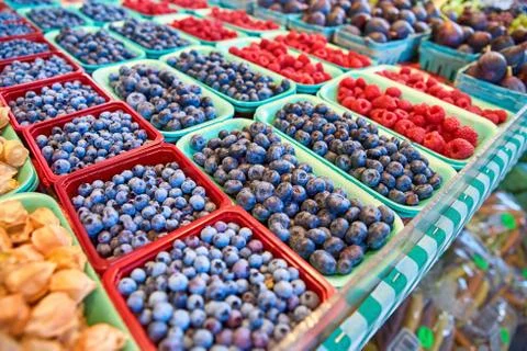 Fresh boxes of assorted berries on display at the farmers market Stock Photos