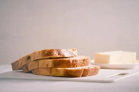 Fresh bread and homemade butter on white table Stock Photos