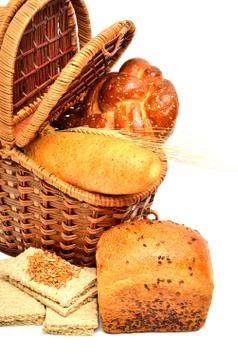 Fresh bread and wheat ear in the basket Stock Photos