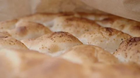 Fresh bread baking in a warm oven at local bakery Видео 337058915