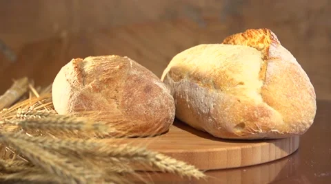 Fresh bread. Bread and wheat ears on the table. Video stock 54792254