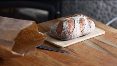 Fresh Bread On A Cutting Board In A Rustic Home Video stock 128305811