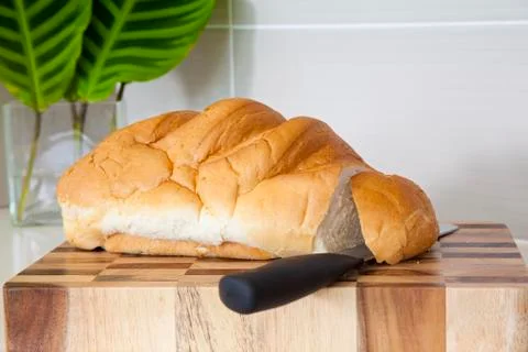 Fresh bread on cutting tray in kitchen Stock Photos