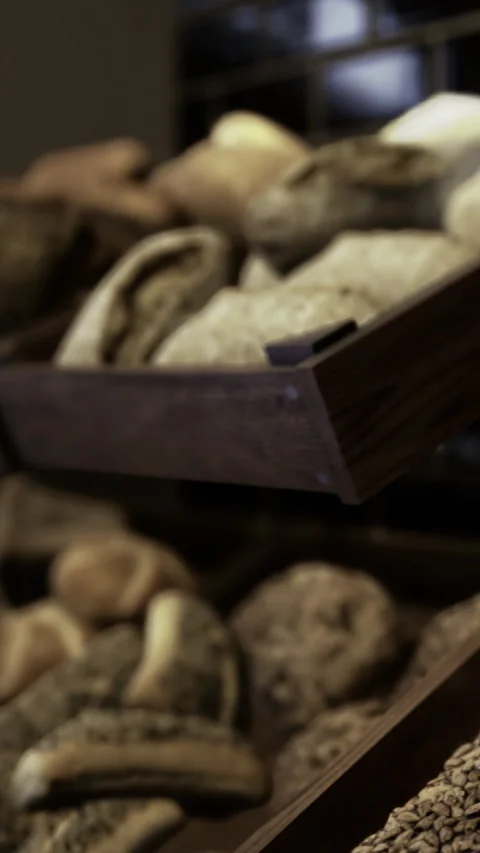 Fresh bread on display in a bakery shop during morning hours Stock Footage 342440773