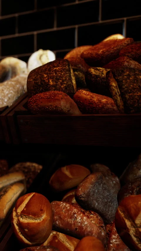 Fresh bread displayed in a bakery with various types and textures Stock Footage 338355192