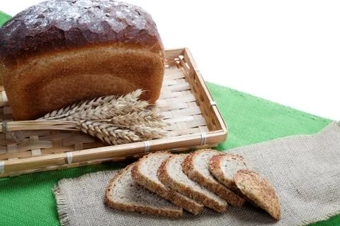 Fresh bread with ears of wheat on the canvas. Stock Photos