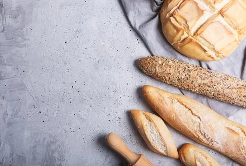 Fresh bread on a gray concrete background. Top view with copy space 写真素材
