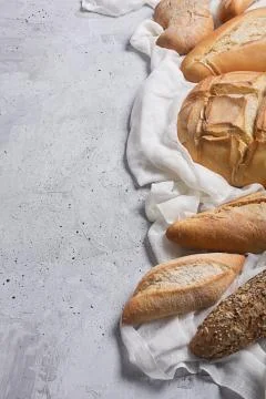 Fresh bread on a gray concrete background. Top view with copy space 写真素材