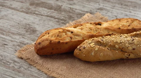 Fresh bread on the kitchen table. Healthy eating and traditional bakery concept Video stock 67721521