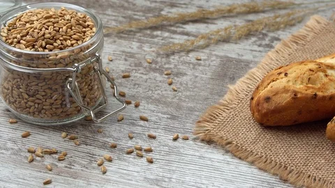 Fresh bread on the kitchen table. Healthy eating and traditional bakery concept Stock Footage 70030154