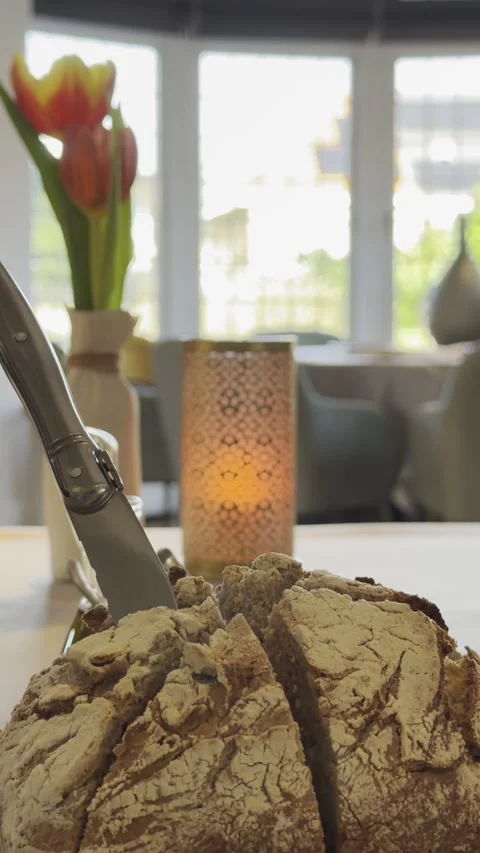 Fresh Bread Loaf with Knife Ready for Cutting at Restaurant Table Stock Footage 330634630
