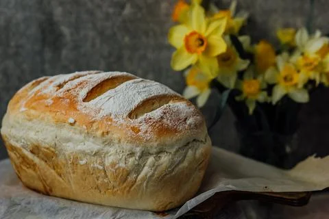 Fresh bread only from the oven, cools down on parchment paper, near beautiful Stock Photos
