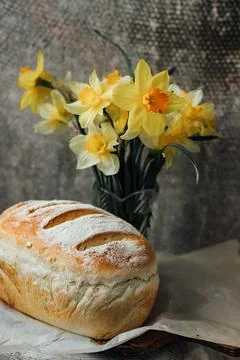 Fresh bread only from the oven, cools down on parchment paper, near beautiful Stock Photos