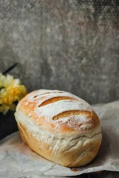 Fresh bread only from the oven, cools down on parchment paper, near beautiful Foto stock