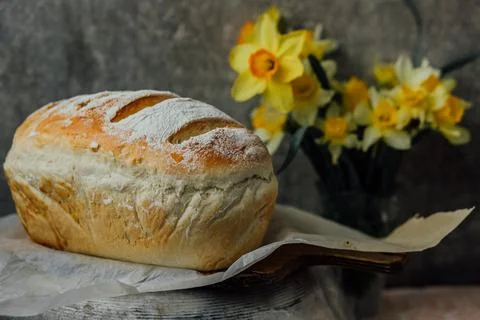 Fresh bread only from the oven, cools down on parchment paper, near beautiful Stock Photos