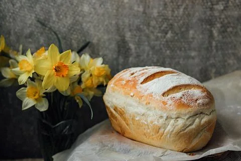 Fresh bread only from the oven, cools down on parchment paper, near beautiful Stock Photos