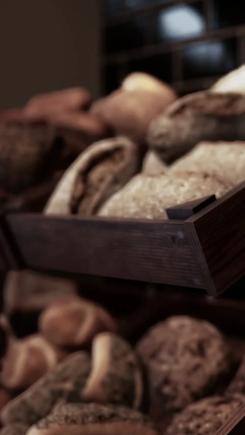 Fresh bread placed in baskets at a bakery during the day Stock Footage 342193411