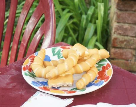 Fresh bread in a plate on a plastic table Stock Photos