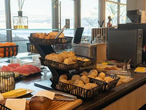 Fresh bread rolls and sliced fruit on a hotel breakfast buffet station, Stock Photos