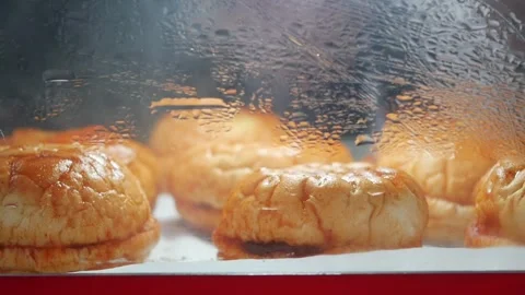 Fresh bread rolls are baking in an oven Stock Footage 333945002
