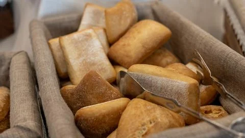Fresh Bread Rolls in Basket with Serving Tongs Stock Photos