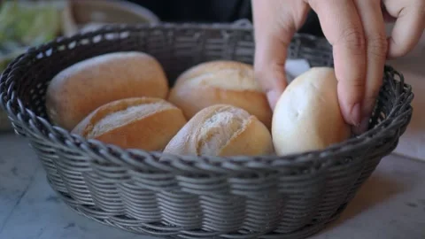 Fresh bread rolls served in a basket at a restaurant Stock Footage 337917682