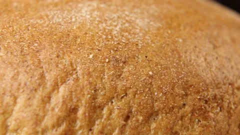 Fresh bread rotates on a black background. Stock Footage 185399057
