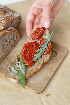 Fresh bread with sun-dried tomatoes and arugula. healthy and delicious lunch Stock Photos