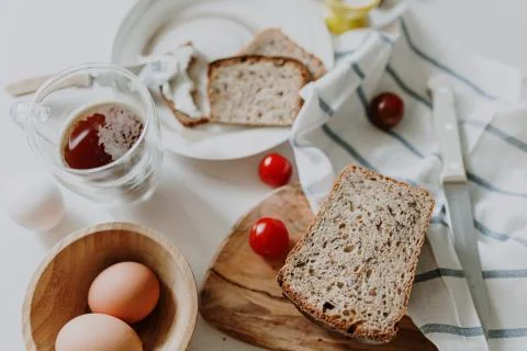 Fresh bread on the table among other breakfast products Stock Photos