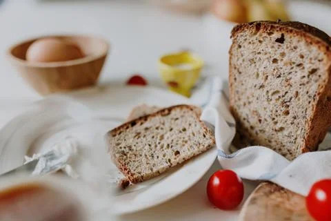 Fresh bread on the table among other breakfast products Stock Photos