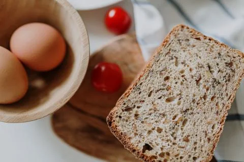 Fresh bread on the table among other breakfast products Stock Photos