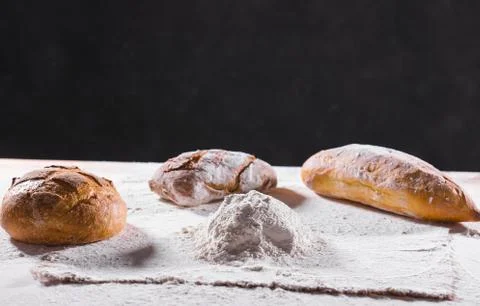 Fresh bread on table close-up in flour placer. Fresh bread on the kitchen table Stock Photos