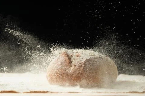Fresh bread on the table close up in a scattering of flour. Fresh bread on th Stock Photos