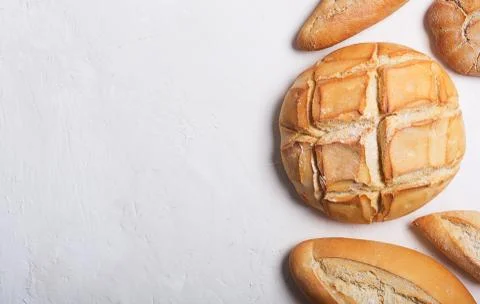 Fresh bread on a white background. Top view with copy space Фото