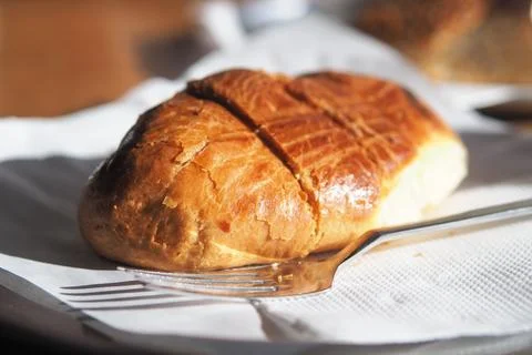 Fresh bread on white napkin with silver fork Stock Photos