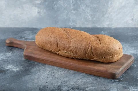 Fresh bread on wooden board. side view Stock Photos