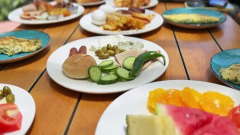 Fresh breakfast buffet spread on wooden dining table Stock Footage 336643832