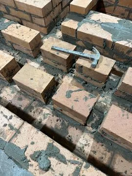 Fresh brickwork of a heating stove bench. The contours of smoke channels are  Stock Photos