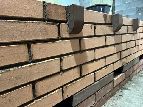 Fresh brickwork of a heating stove bench with decorative elements. Close-up. Foto stock