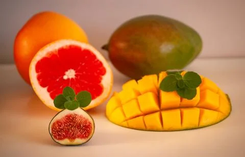 Fresh bright mango fruit, figs, grapefruit, orange Stock Photos