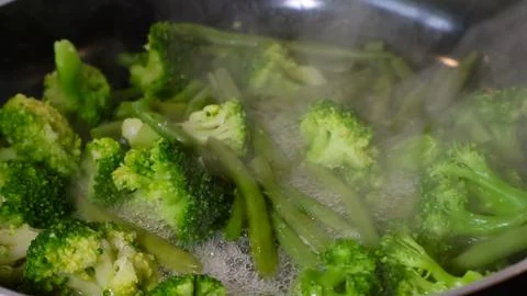 Fresh broccoli and green beans steaming for healthy eating Stock Photos