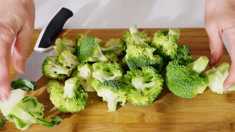 Fresh broccoli being cut into florets for cooking. Stock Footage 308151162