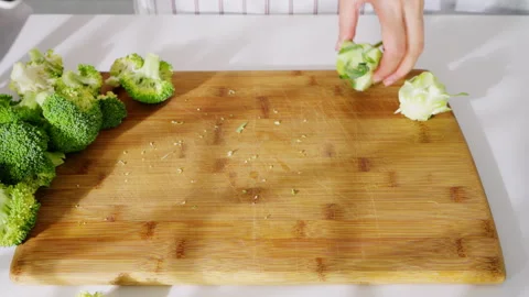 Fresh broccoli being cut into florets for cooking. Stock Footage 308160364