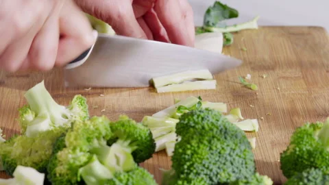 Fresh broccoli being cut into florets for cooking. Stock Footage 331145093