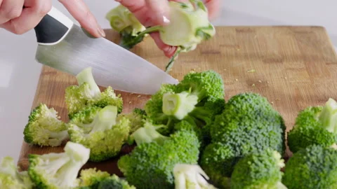 Fresh broccoli being cut into florets for cooking. Stock Footage 331145495