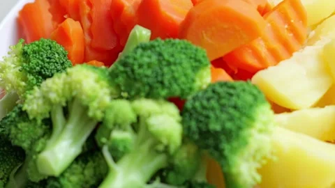 Fresh Broccoli Carrot Potato Vegetable Assortment with Colorful Sliced Produce Stock Footage 346328283
